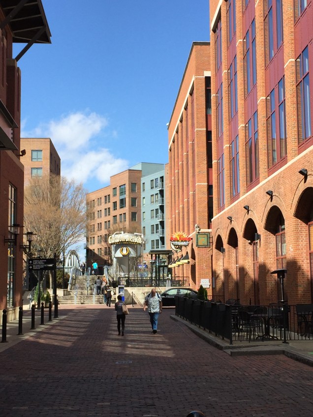 Looking down a pedestrian walkway leading away from Nationwide Arena and towards a half dozen bars.